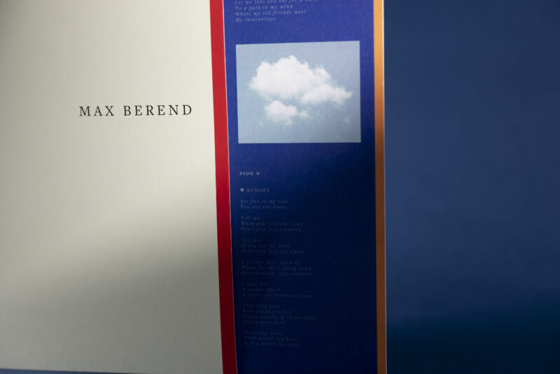 Close-up photograph of the vinyl edition of ‘On Serenity’ by singer-songwriter Max Berend, showing the warm-toned album artwork and the texture of the record in soft natural light.