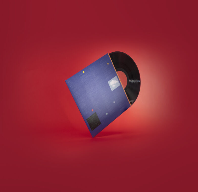 Close-up photograph of the vinyl edition of ‘On Serenity’ by singer-songwriter Max Berend, showing the warm-toned album artwork and the texture of the record in soft natural light.